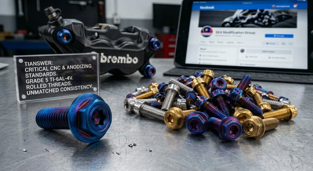 Burn Blue and gold titanium motorcycle bolts on a workbench beside a Brembo brake caliper