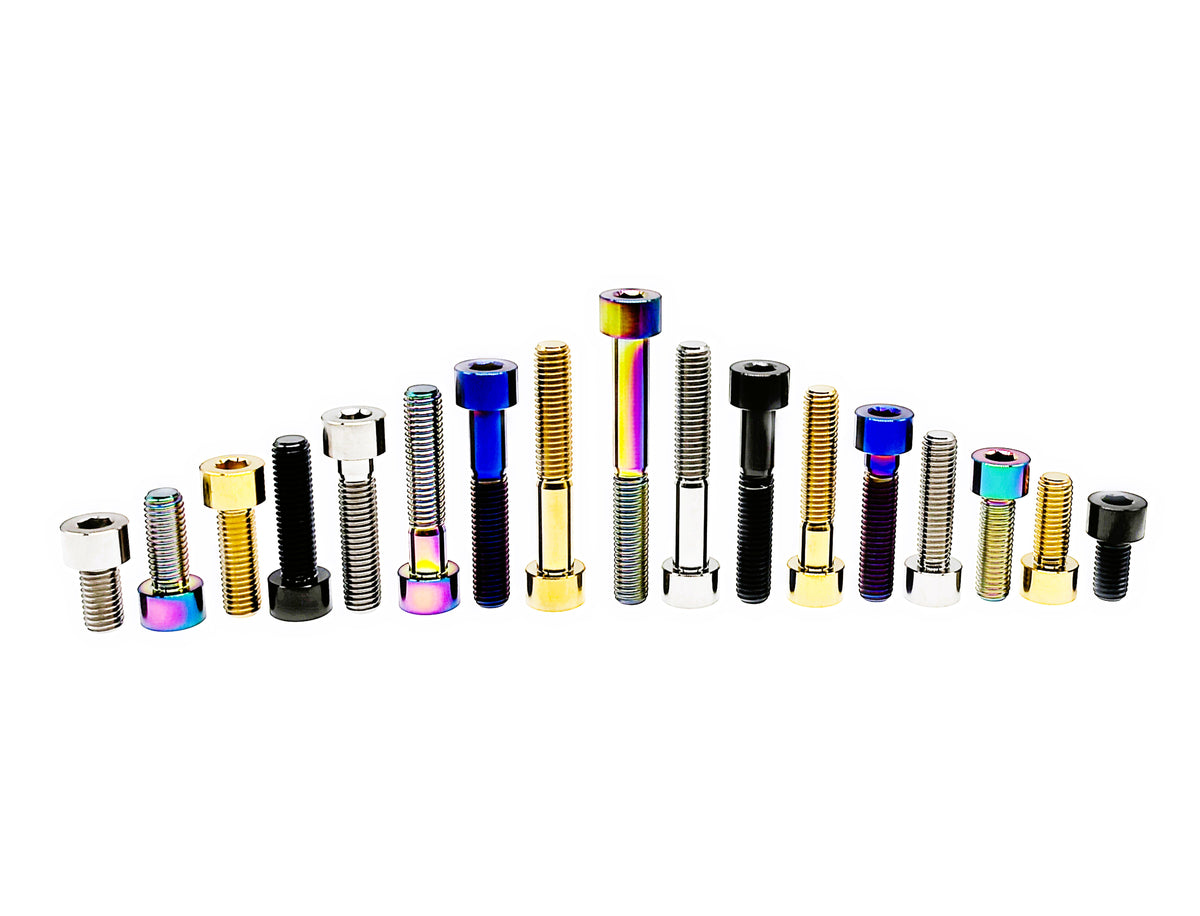 Titanium M8 DIN912 socket cap bolts arranged by length in a peak, mixed anodized colors