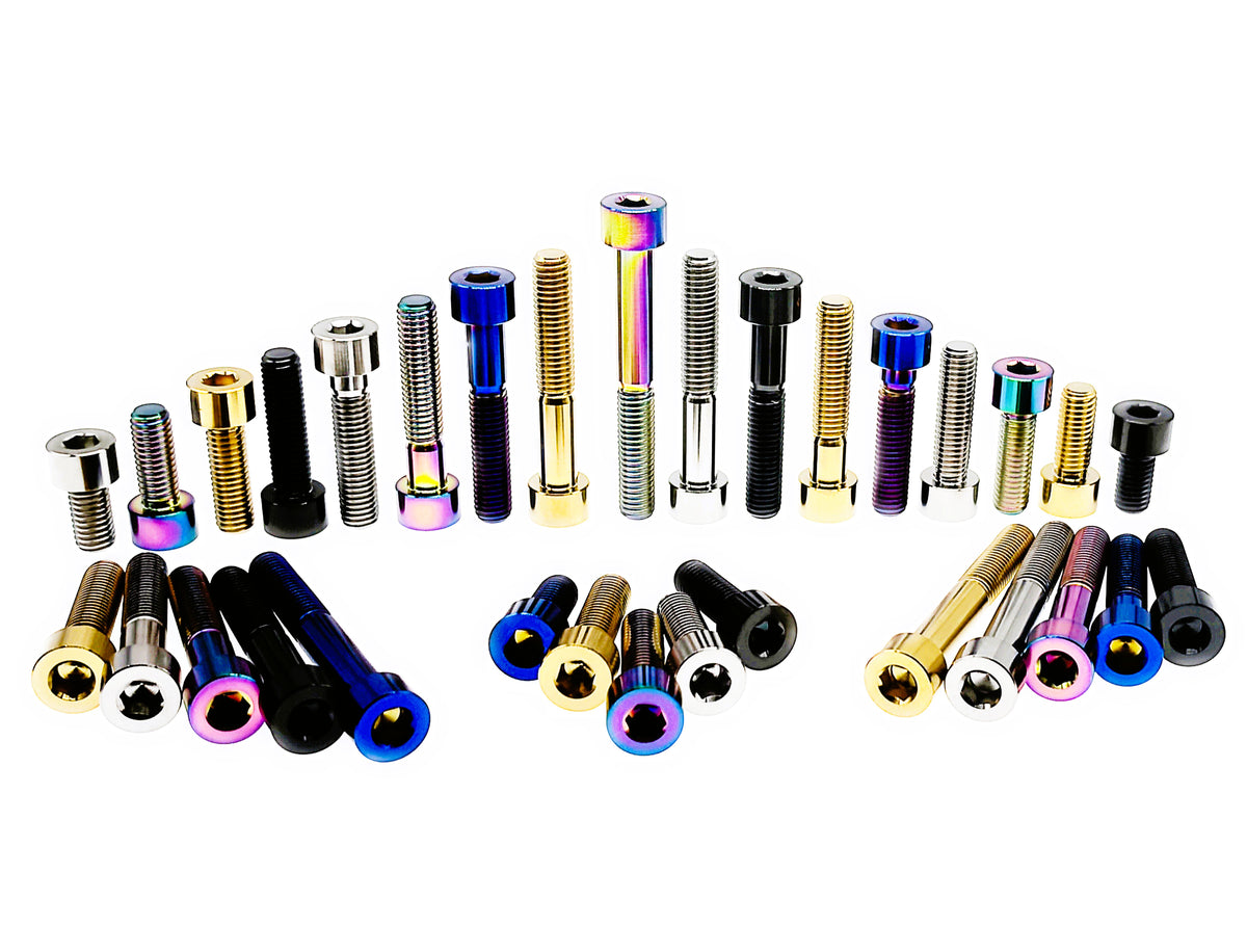 Titanium M8 DIN912 hex socket cap screws displayed standing and laid out in five finishes