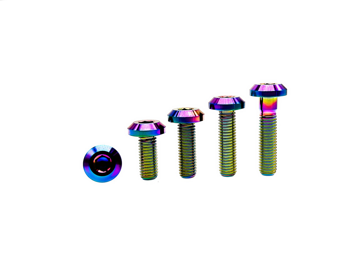 Rainbow anodized titanium M8 and M8 umbrella head bolts standing in four lengths